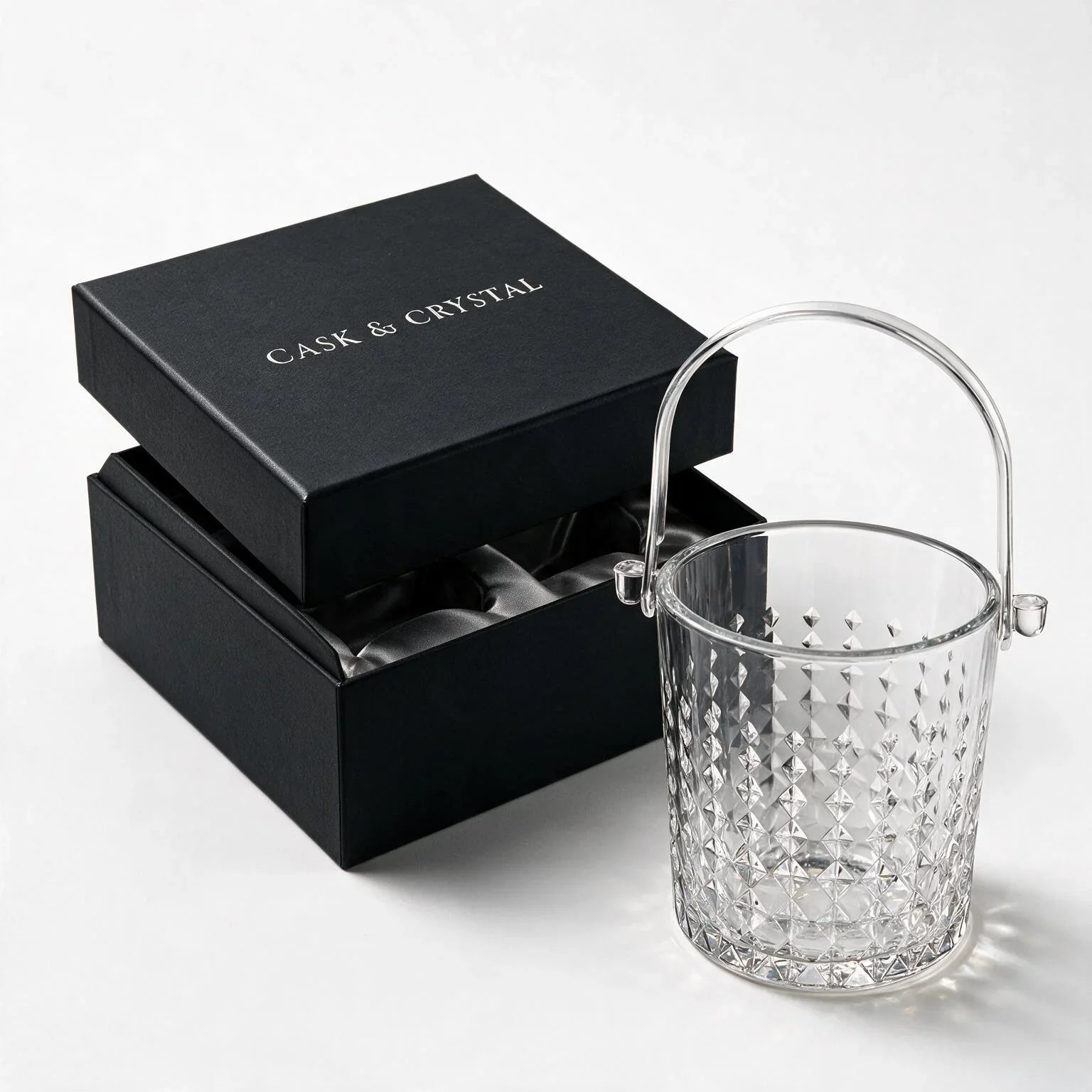Valen clear glass ice bucket with diamond cut facets and a metal handle