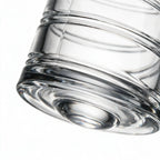 Helix clear whisky glass with a slanted rim and sweeping textured design