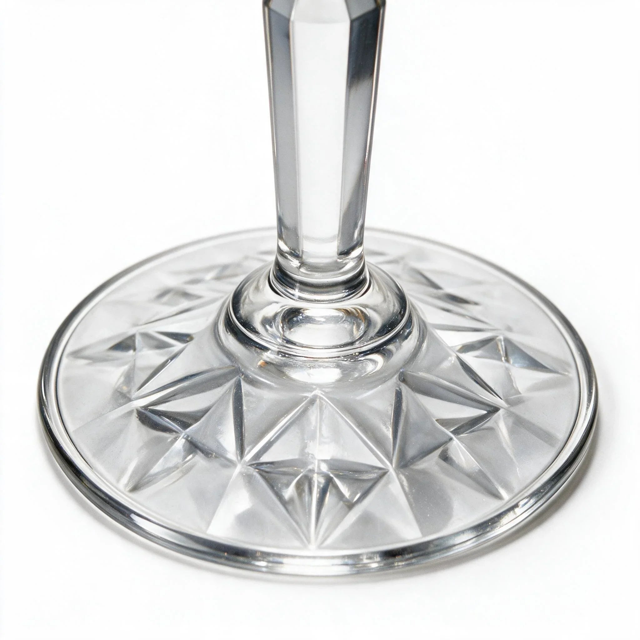 Lumina clear cocktail glass with a tall stem and geometric diamond cut bowl