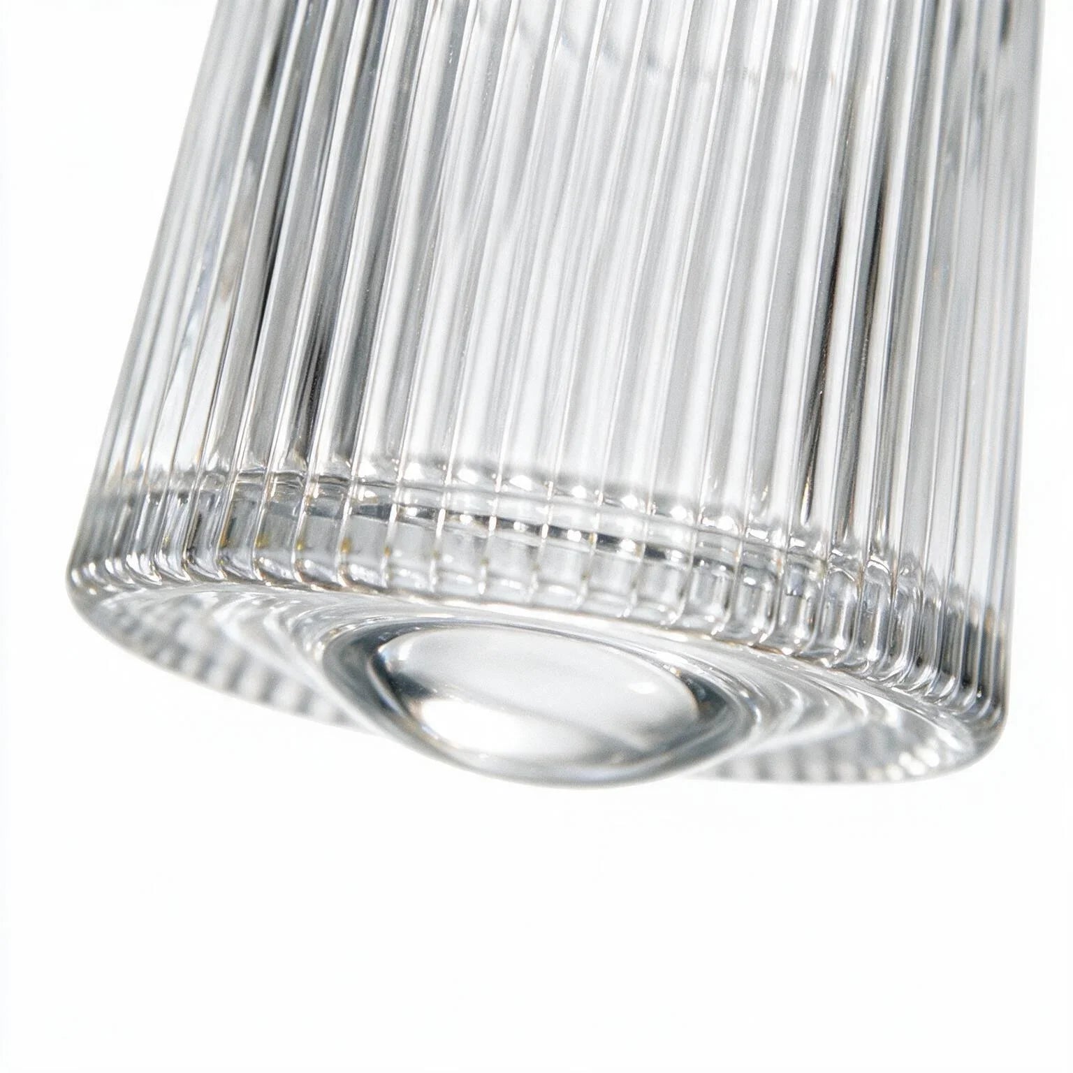 Coda clear whisky glass with a rotating base and ribbed texture