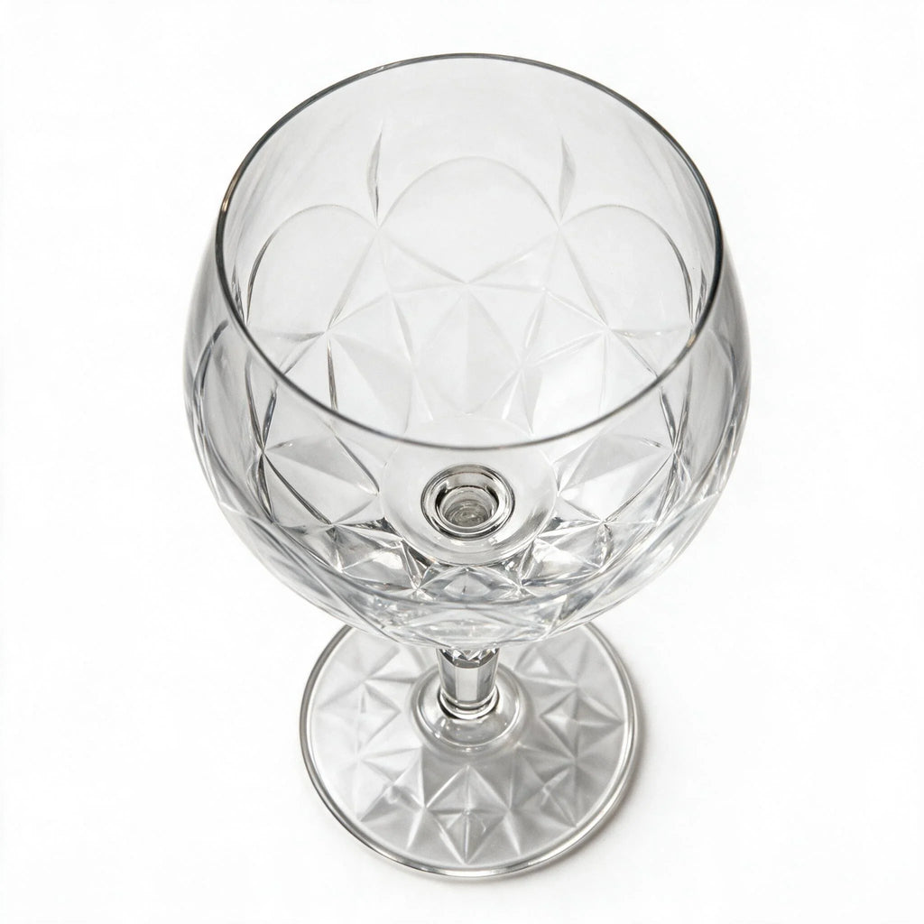 Lumina clear cocktail glass with a tall stem and geometric diamond cut bowl