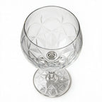 Lumina clear cocktail glass with a tall stem and geometric diamond cut bowl
