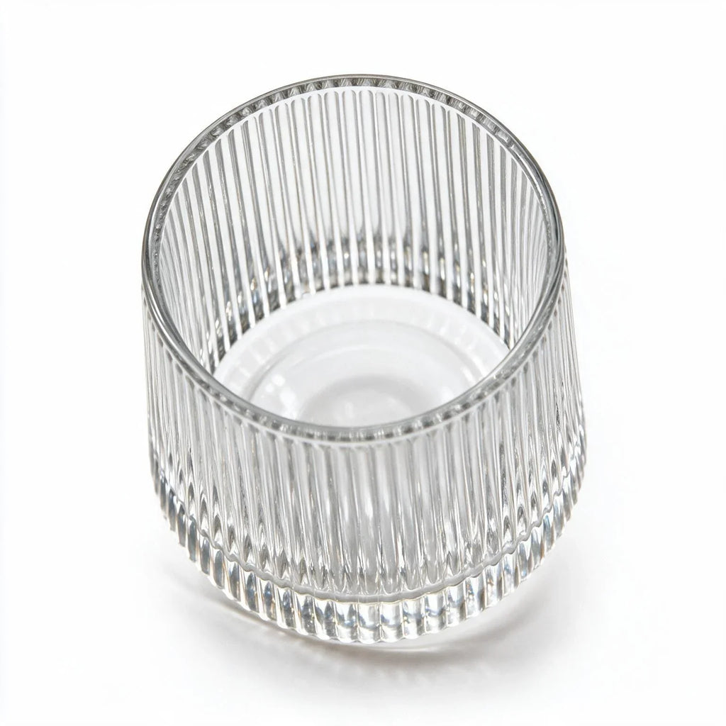Coda clear whisky glass with a rotating base and ribbed texture