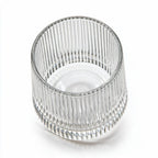 Coda clear whisky glass with a rotating base and ribbed texture