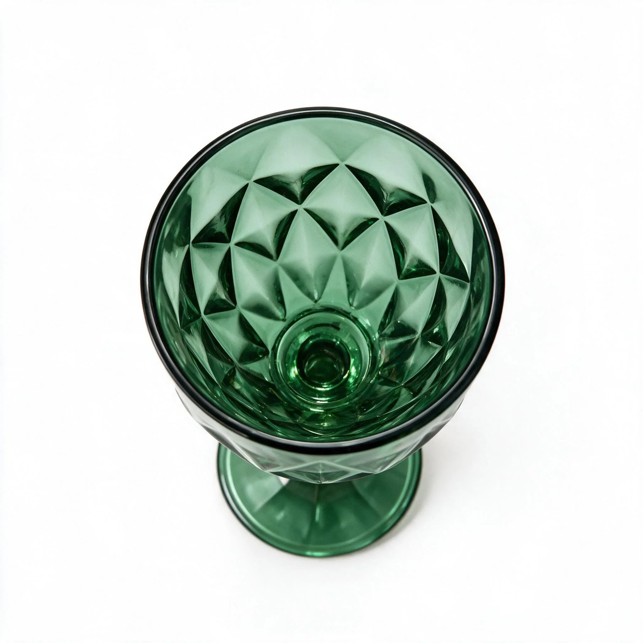 Sylvan green cocktail glass with diamond cut facets and a short stem