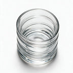 Helix clear whisky glass with a slanted rim and sweeping textured design