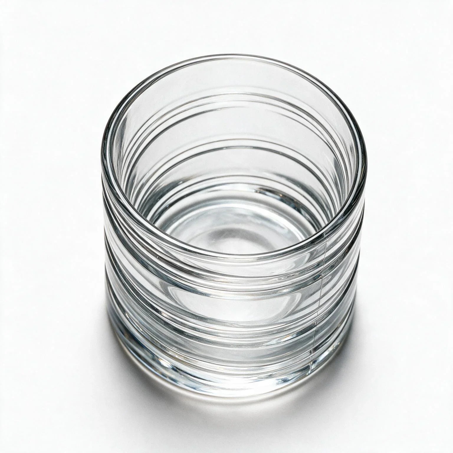 Helix clear whisky glass with a slanted rim and sweeping textured design