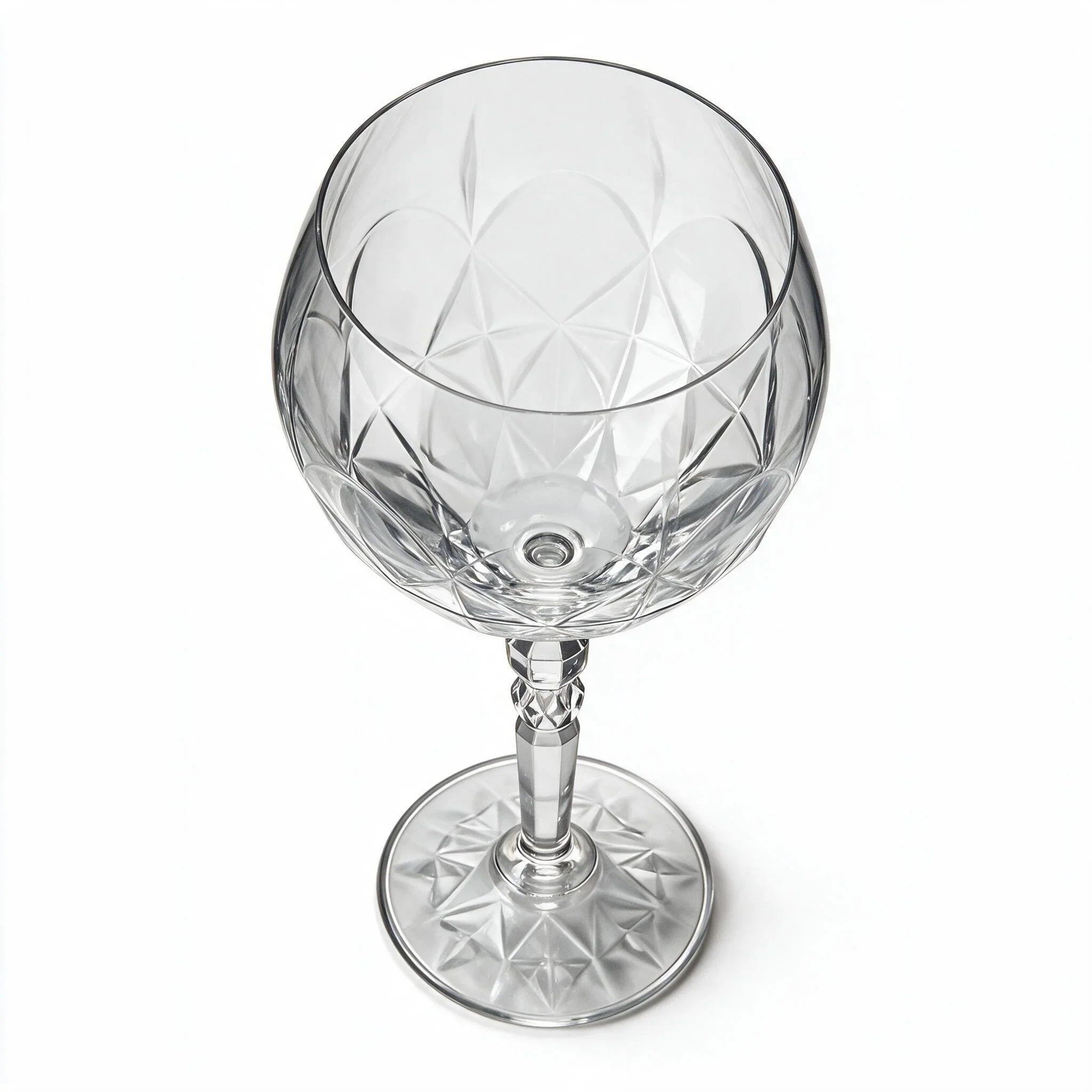 Lumina clear cocktail glass with a tall stem and geometric diamond cut bowl