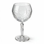 Lumina clear cocktail glass with a tall stem and geometric diamond cut bowl