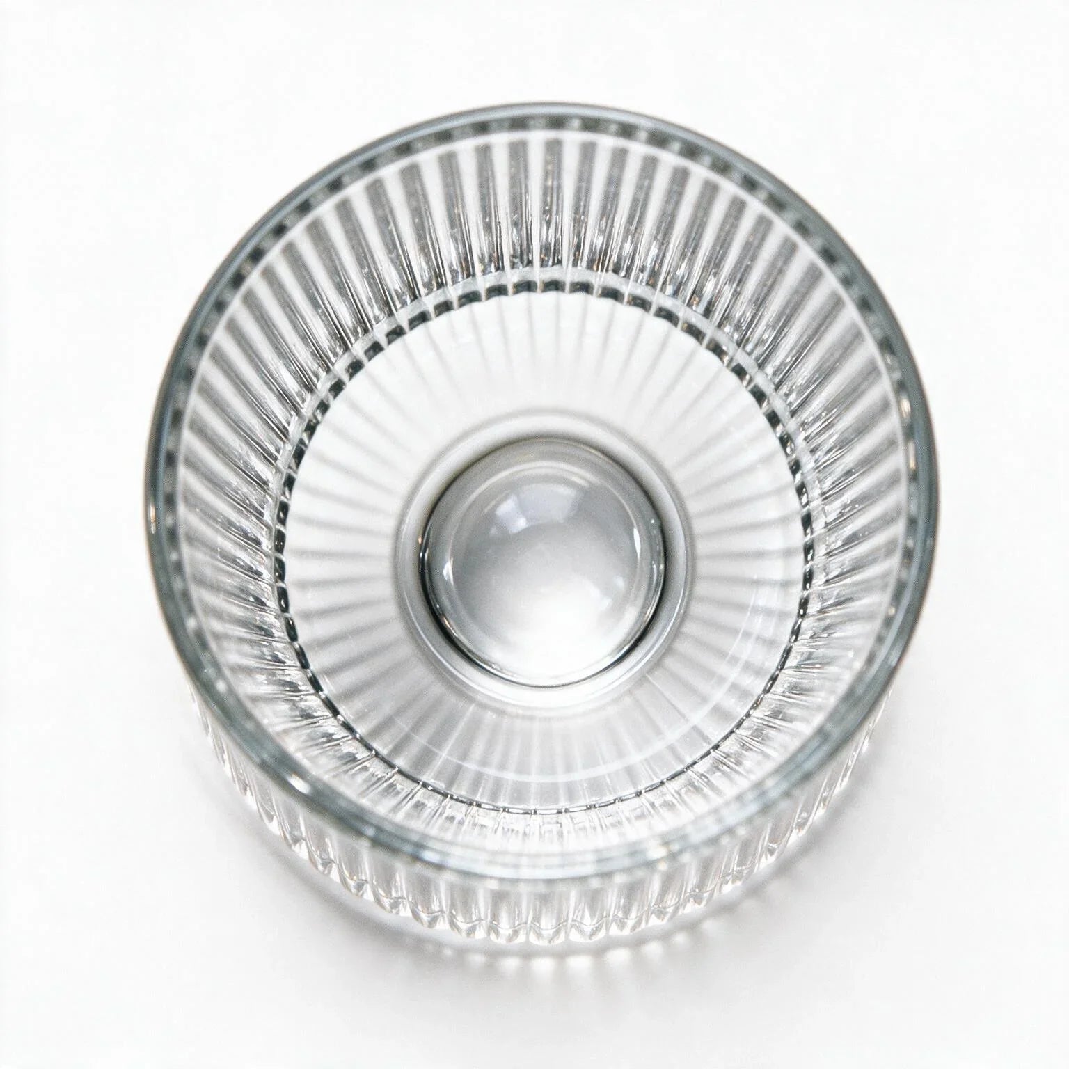 Coda clear whisky glass with a rotating base and ribbed texture