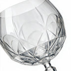 Lumina clear cocktail glass with a tall stem and geometric diamond cut bowl