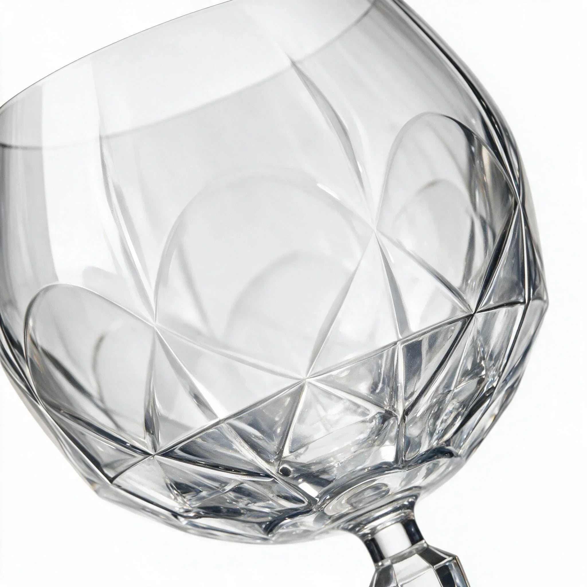 Lumina clear cocktail glass with a tall stem and geometric diamond cut bowl
