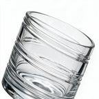 Helix clear whisky glass with a slanted rim and sweeping textured design