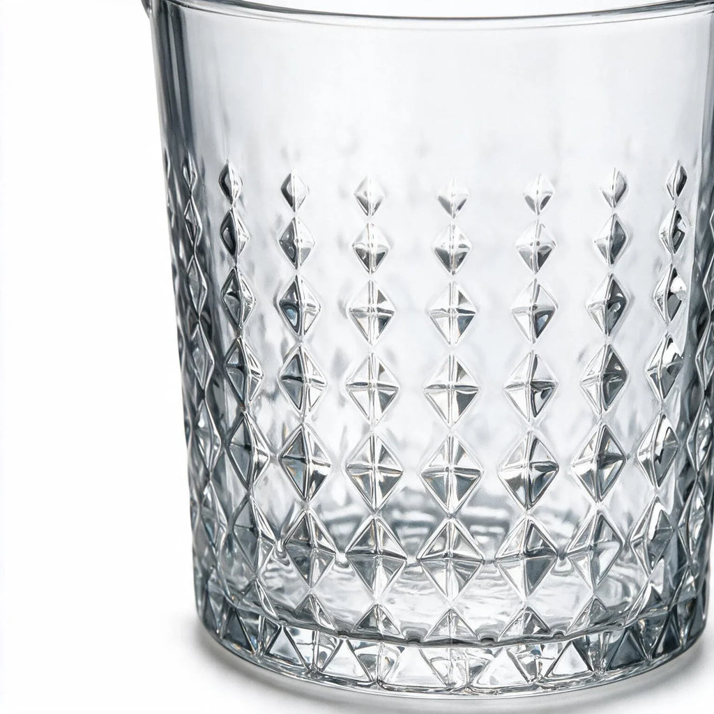 Valen clear glass ice bucket with diamond cut facets and a metal handle